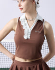 Brown cropped tennis top with ruffled collar and sleeveless design, featuring a subtle logo for a chic, sporty look.