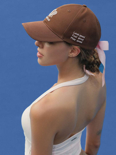 Brown tennis baseball cap with embroidered Pom Pêche logo and detachable ribbon.