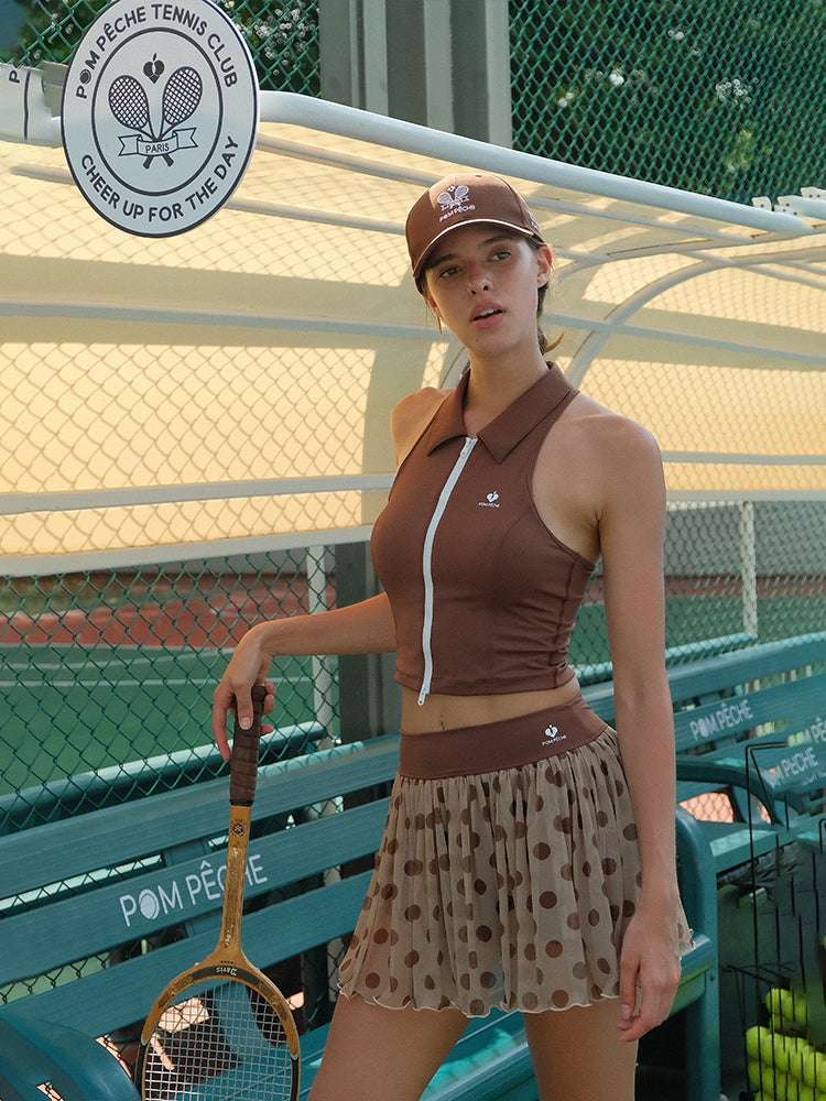 Brown zip-front tennis tank with a collar and subtle logo, offering a chic look for on-court wear.