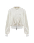 Cream fleece zip-up jacket with a soft texture and subtle logo detail, offering a polished yet cozy look.