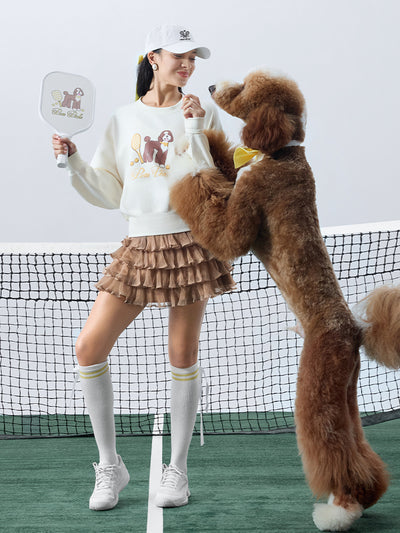 Soft, casual sweatshirt featuring a playful dog-and-tennis graphic, perfect for relaxed, sporty looks.