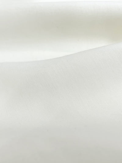 Close-up of cream sweatshirt's fabric material. 