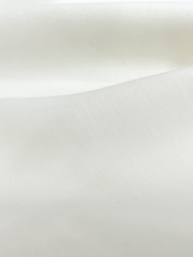 Close-up of cream sweatshirt's fabric material. 