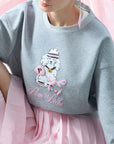 Soft, casual sweatshirt featuring a playful dog-and-tennis graphic, perfect for relaxed, sporty looks.