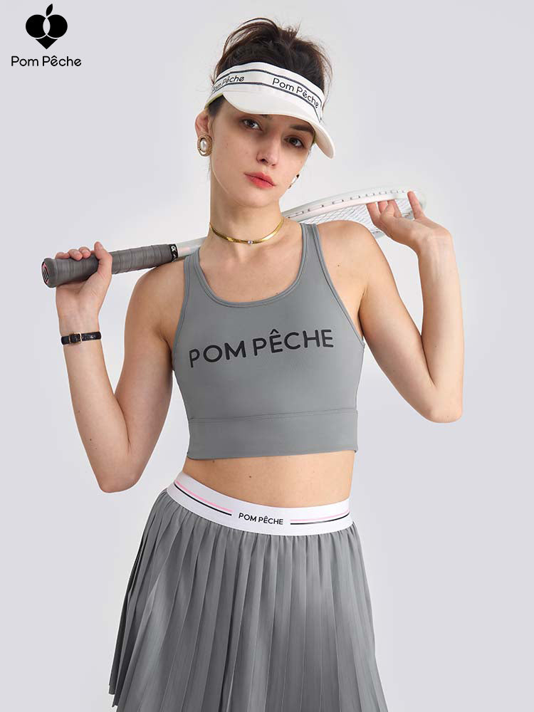 Gray sports bra with brand logo, designed for comfort and style during active sports.