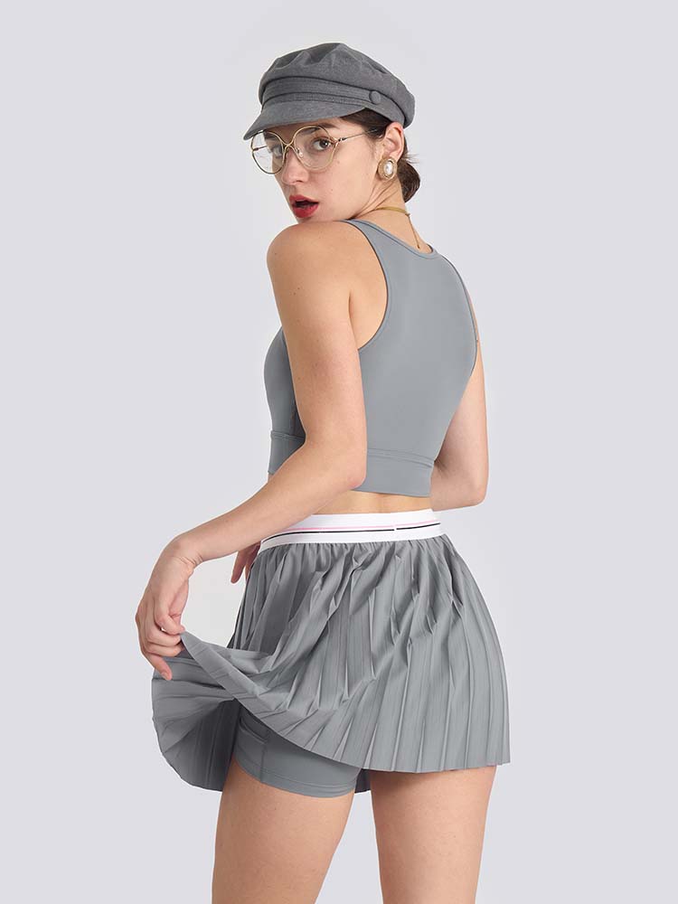 Gray sports bra with brand logo, designed for comfort and style during active sports.