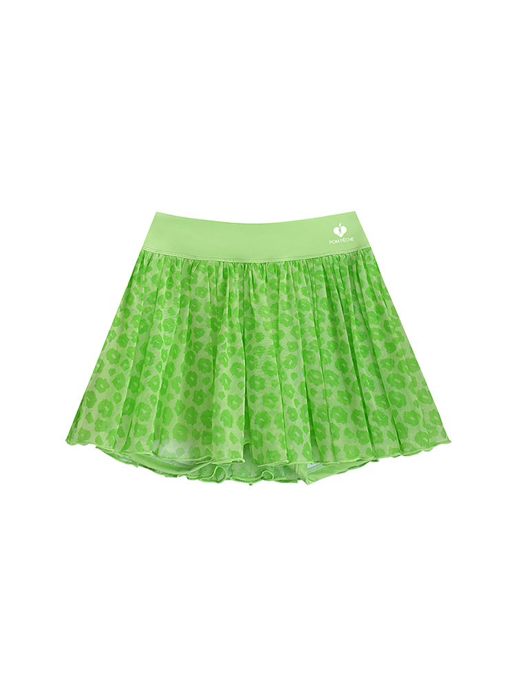 A product shot of a green leopard print mesh tennis skirt featuring airy pleated mesh and a wide waistband for secure movement.