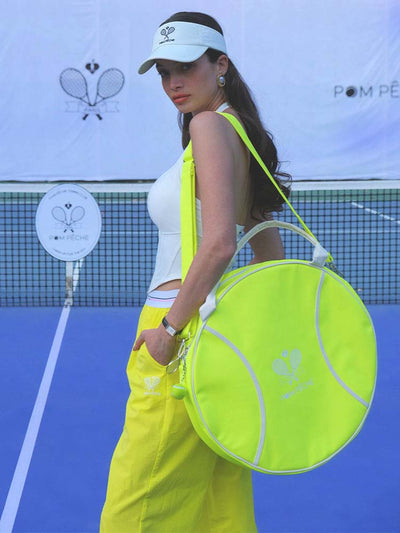 Green round tennis bag with white trim and handles, featuring Pom Pêche logo.
