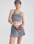 A classic grey pleated tennis skirt for women featuring a flowy athletic silhouette, ideal for tennis, pickleball, and active outfits.