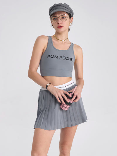 A classic grey pleated tennis skirt for women featuring a flowy athletic silhouette, ideal for tennis, pickleball, and active outfits.