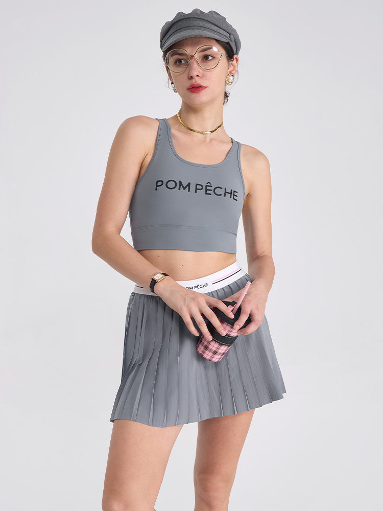 A classic grey pleated tennis skirt for women featuring a flowy athletic silhouette, ideal for tennis, pickleball, and active outfits.
