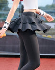 Grey tennis leggings with a tiered ruffle skirt and high waist, stretchy fabric for comfort and active movement .