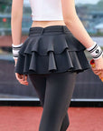 Grey tennis leggings with a tiered ruffle skirt and high waist, stretchy fabric for comfort and active movement .