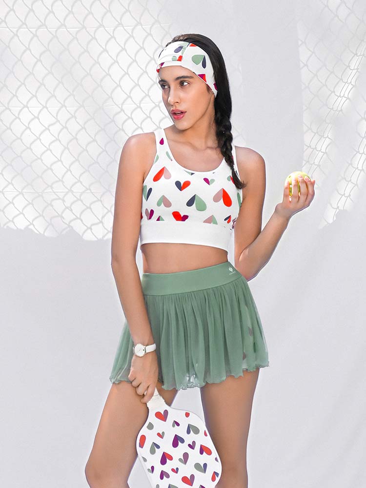 White sports bra with printed heart patterns, designed for comfort and style during active sports.