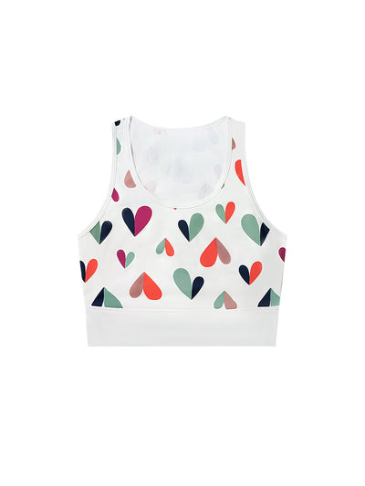 White sports bra with printed heart patterns, designed for comfort and style during active sports.