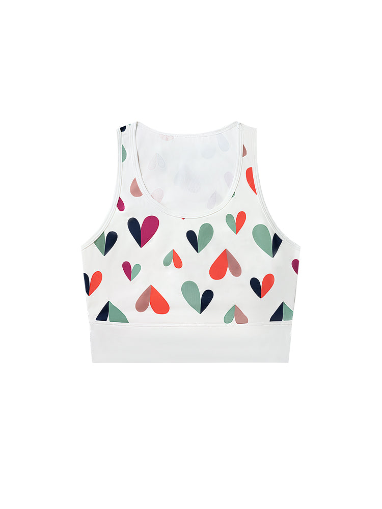 White sports bra with printed heart patterns, designed for comfort and style during active sports.