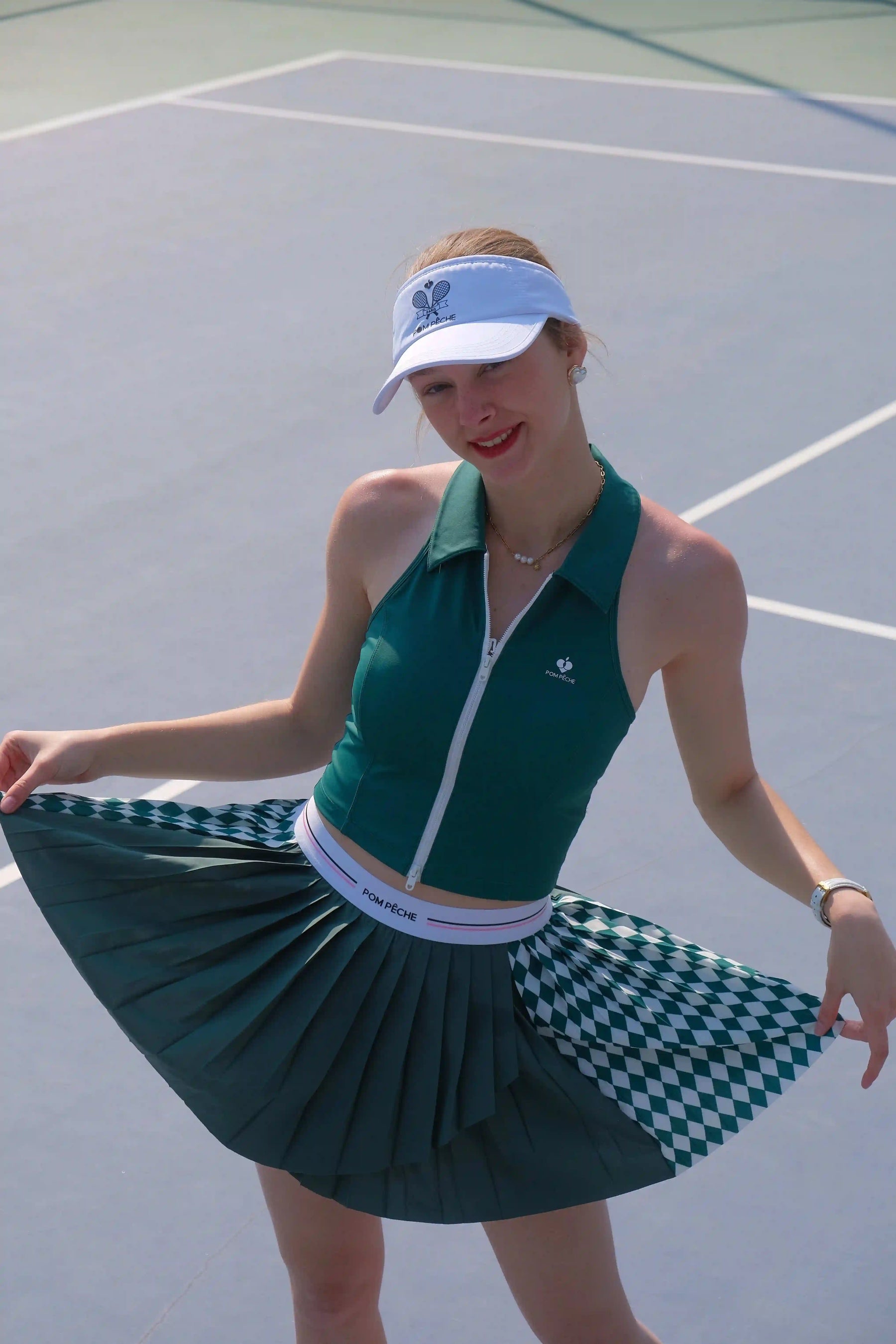 Woman in green tennis outfit on a tennis court