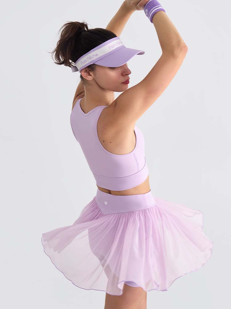 Light purple sports bra with brand logo, designed for comfort and style during active sports.