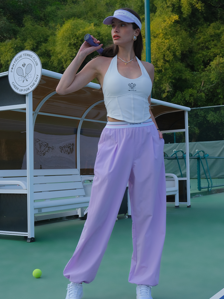 Light purple wide-leg tennis pants with an elastic waist and adjustable hems. 
