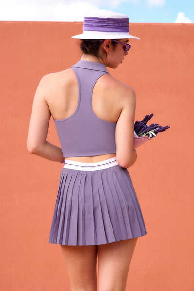 Light purple zip-front tennis tank with a collar and subtle logo, offering a chic look for on-court wear.