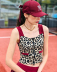 Leopard print sports tank with contrast straps and a zip front. Fitted, chic, and perfect for elevating on-court look.
