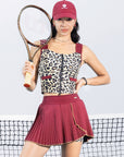 Leopard print sports tank with contrast straps and a zip front. Fitted, chic, and perfect for elevating on-court look.