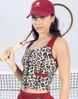 Leopard print sports tank with contrast straps and a zip front. Fitted, chic, and perfect for elevating on-court look.