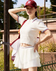 White cropped polo styled with tennis skirt for elevated courtside look