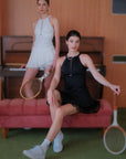 Two models wearing black and white mesh halter tank 