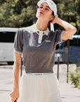 Outdoor photos of a model wearing the Grey Poise™ knit polo shirt.