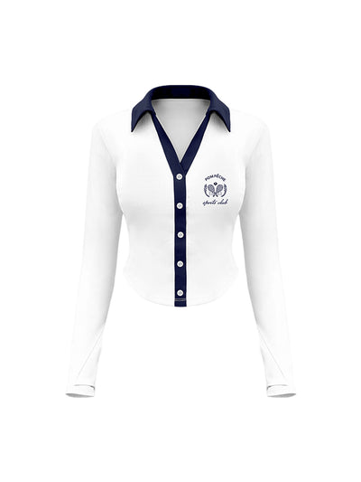 White polo top with navy blue collar and printed logo, worn on the city street for a stylish, casual look.