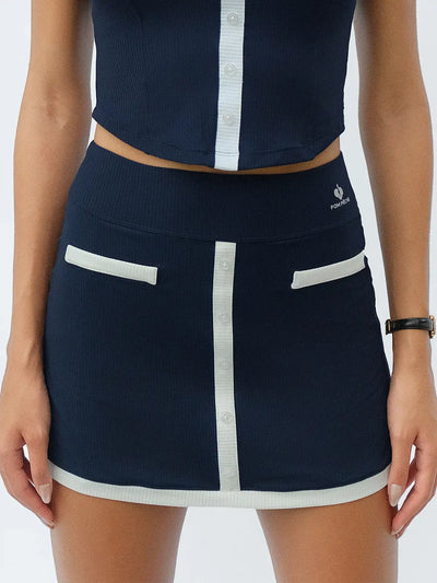 Navy blue tennis mini skirt with contrast trims and button-front detail, offering a neat, preppy look for court or casual wear.