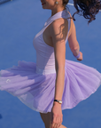 Lavender tulle puff tennis skirt flowing in motion on court, highlighting airy layered mesh and a high-waisted athletic tennis skirt silhouette.