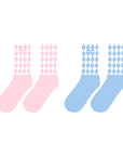 Pink and blue mid-crew socks with checkered pattern and Pom Pêche logo, styled with a soft, casual aesthetic.
