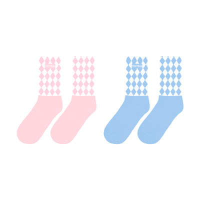 Pink and blue mid-crew socks with checkered pattern and Pom Pêche logo, styled with a soft, casual aesthetic.