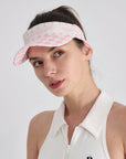 Pink checkered tennis visor with Pom Pêche logo and adjustable strap.