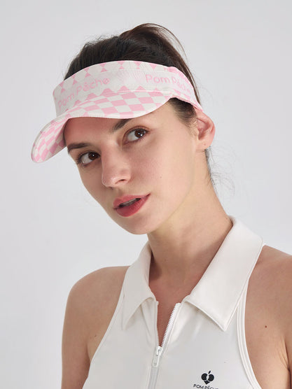 Pink checkered tennis visor with Pom Pêche logo and adjustable strap.