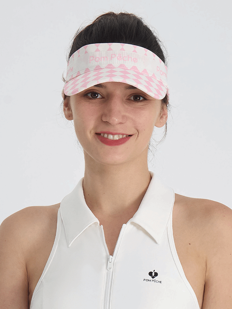 Pink checkered tennis visor with Pom Pêche logo and adjustable strap.