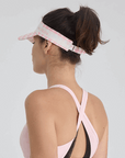 Pink checkered tennis visor with Pom Pêche logo and adjustable strap.