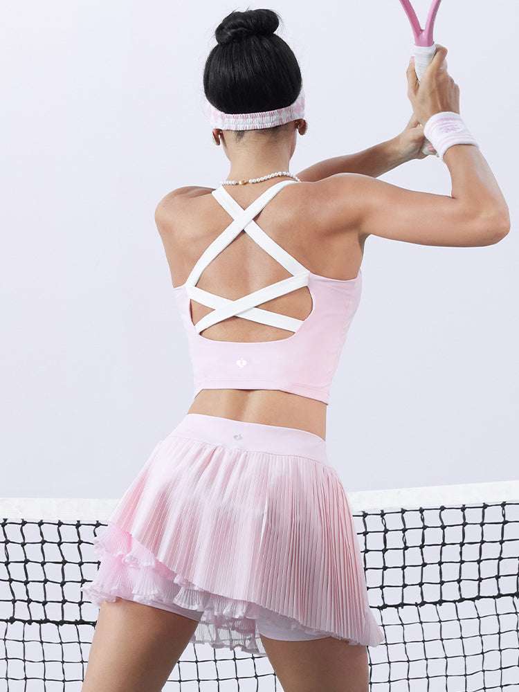 Pink cropped tank top with contrast trim, bow detail, and printed logo for a sleek, sporty look.