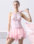 Women’s mesh halter tank and tiered tennis skirt set on tennis court, breathable sporty tennis outfit for performance and training