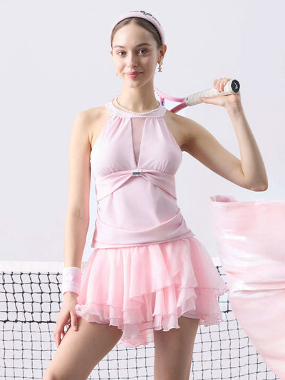 Women’s mesh halter tank and tiered tennis skirt set on tennis court, breathable sporty tennis outfit for performance and training