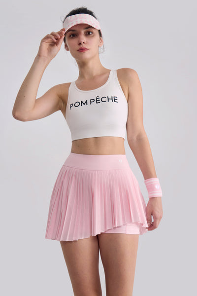 Front-facing pose showcasing high-waisted pleated skirt with built-in shorts for coverage and movement