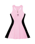 Pink V-neck tennis dress with black curved side panels, styled on the court.