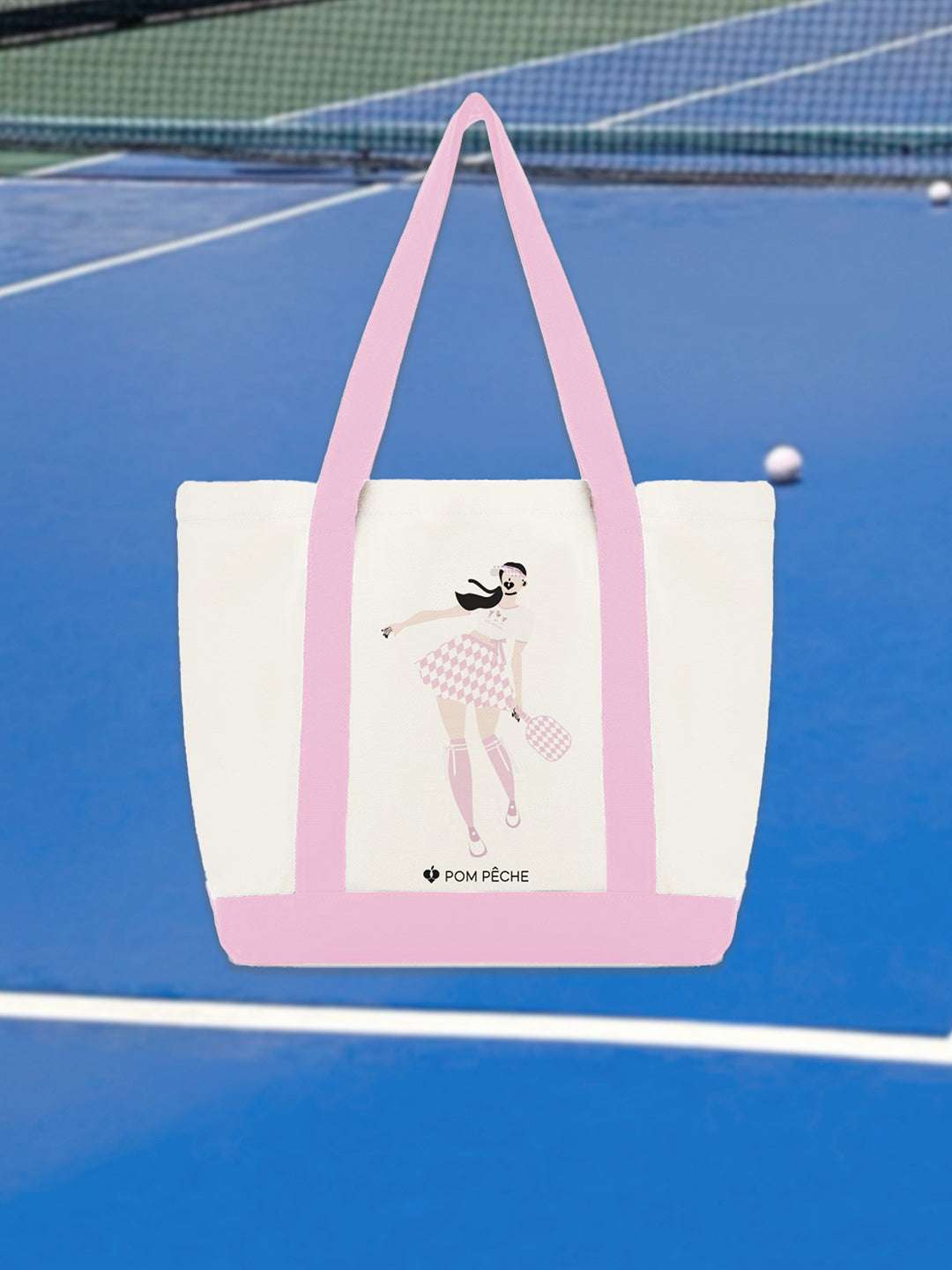 Canvas tote bag with pink strap handles, featuring a printed Tennis Girl graphic.