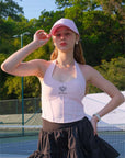 Soft pink tennis baseball cap with embroidered Pom Pêche logo. 