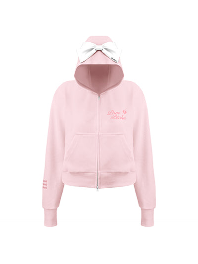 Soft pink zip-up hoodie with bow detail on the hood and embroidered logo, perfect for warm-ups or everyday wear.