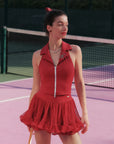 Woman in a red outfit on a tennis court
