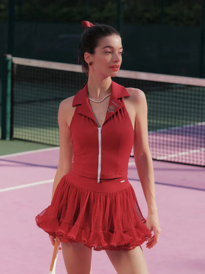 Woman in a red outfit on a tennis court