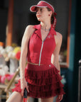 Woman wearing a red outfit with a matching visor in an outdoor setting